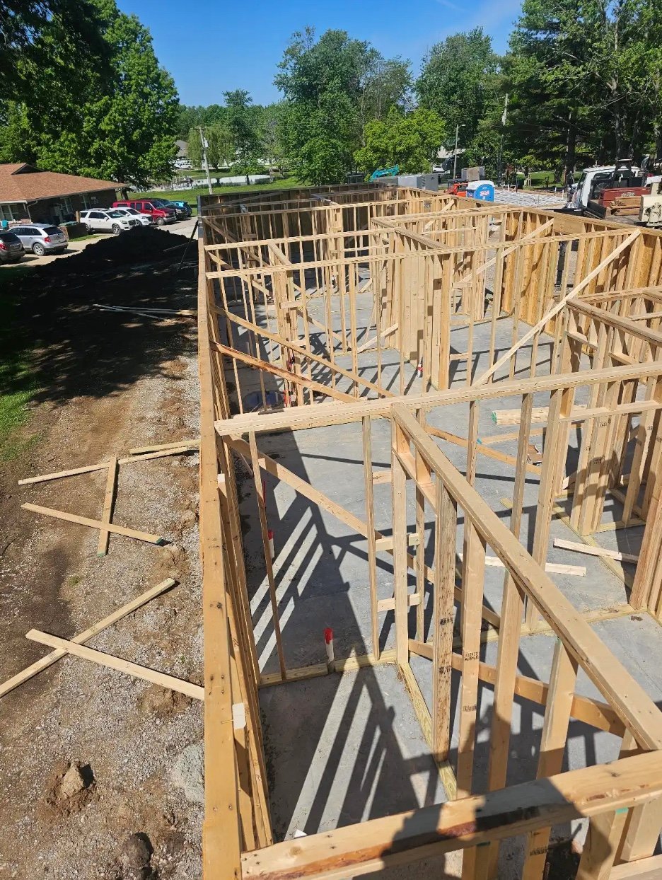 Construction site with concrete foundation and wooden framing