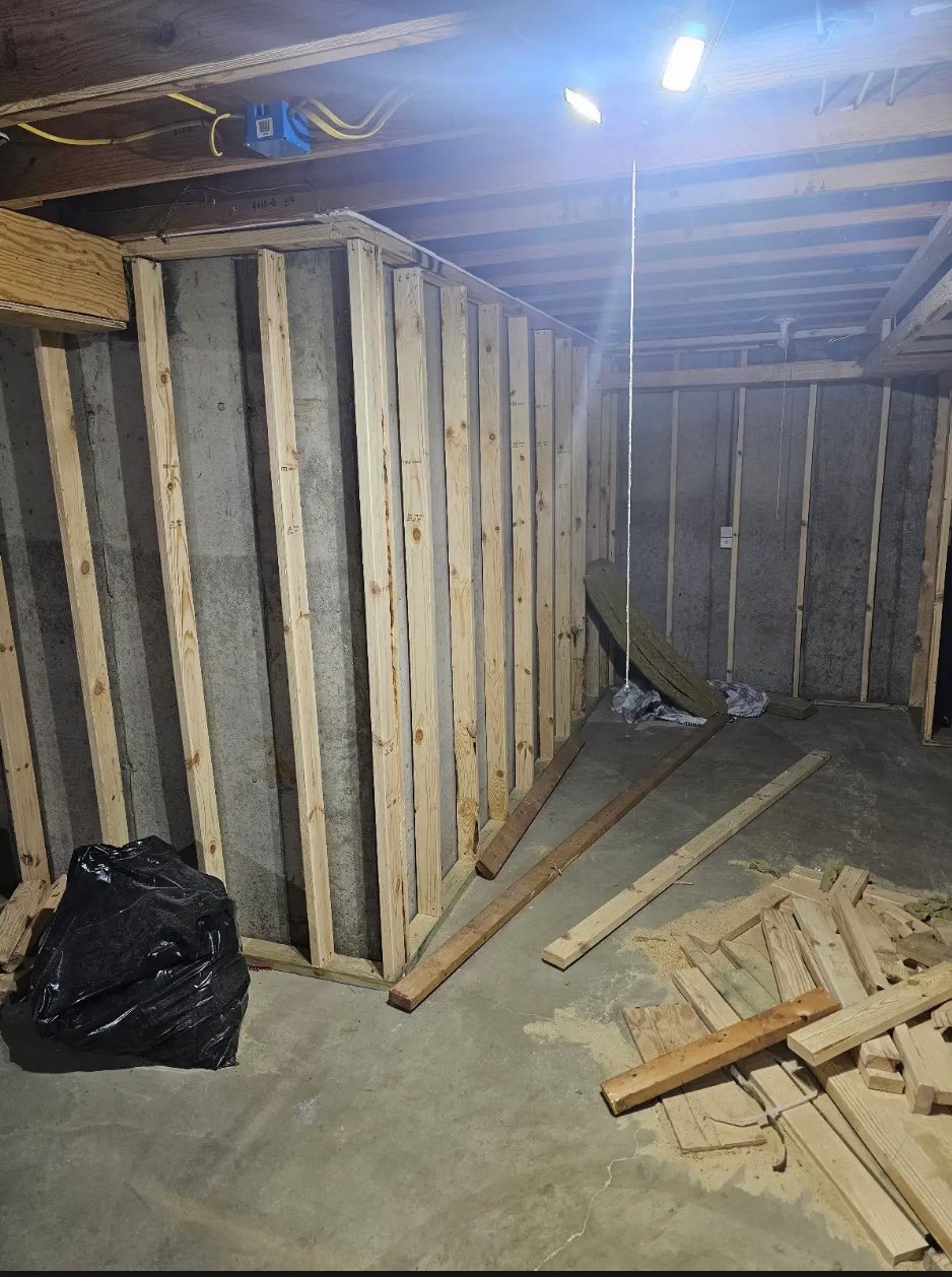 Interior construction with wooden wall framing and metal panels
